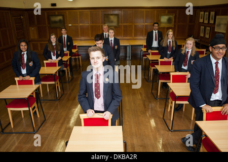 Teenage schoolchildren standing in exam class Stock Photo
