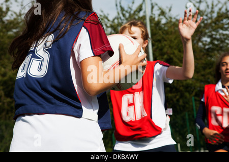Teenage schoolgirl netball players defending Stock Photo