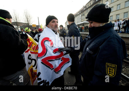 Stuttgart, Germany. 04th Dec, 2013. An opponent of Stuttgart 21, with a banner reading S21 wrapped around his shoulders, is photographed in Stuttgart, Germany, 04 December 2013. The construction work on the first tunnel of the controversial railway and urban development project is about to begin. Photo: MARIJAN MURAT/dpa/Alamy Live News Stock Photo