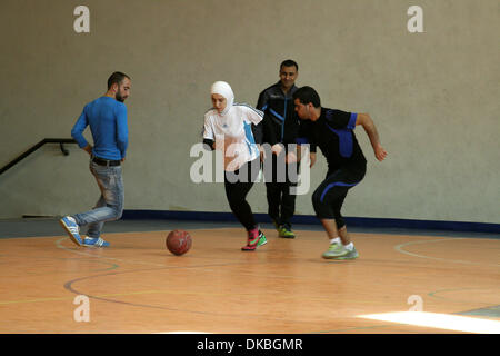 Nablus, West Bank, Palestinian Territory, . 4th Dec, 2013. Abir Harb, a 18 year-old Palestinian referee, demonstrates her skills at the stadium of An-Najah national University, in the West Bank City of Nablus, Dec. 04, 2013. Harb is a student in the faculty of sport education and a soccer player, she has obtained the International FIFA Referee Certificate which enables her to referee any soccer championships in the world © Nedal Eshtayah/APA Images/ZUMAPRESS.com/Alamy Live News Stock Photo