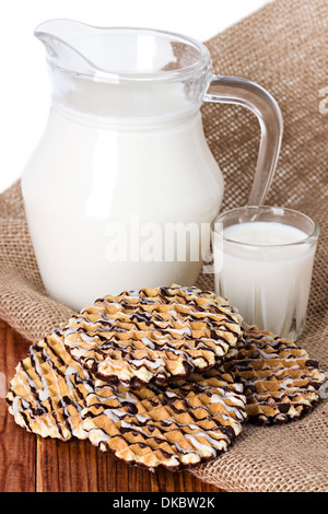 Composition milk in a jug, a glass on burlap background Stock Photo