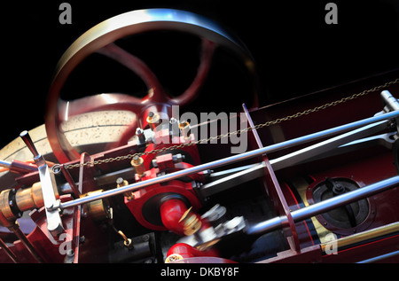 Flywheel and close up of moving parts of a small traction engine. Stock Photo