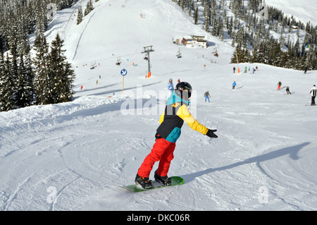 Snowboarding boy in Austrian Ski resort. Stock Photo