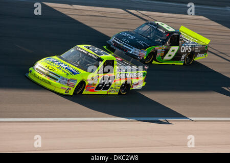 Oct. 15, 2011 - Las Vegas, Nevada, U.S - Matt Crafton, driver of the #88 Ideal Door / Menards Chevrolet Silverado, tries his best to hold off Nelson Piquet Jr., driver of the #8 Qualcomm / Fleet Solutions Chevrolet Silverado, during the exciting truck racing action at the NASCAR Camping World Truck Series Smith's 350 at Las Vegas Motor Speedway in Las Vegas, Nevada. (Credit Image:  Stock Photo