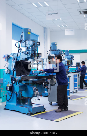 Workers at small parts manufacturing factory in China Stock Photo