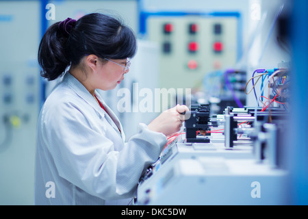 Worker at small parts manufacturing factory in China Stock Photo