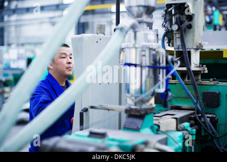 Worker at small parts manufacturing factory in China Stock Photo