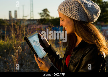 Young woman looking at digital tablet screen Stock Photo