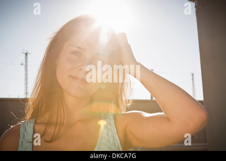 Portrait of young woman with hand in hair Stock Photo