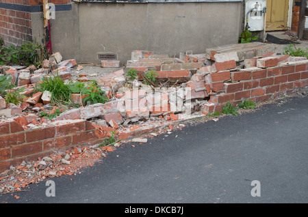 Front Garden wall of house suffering impact damage Stock Photo