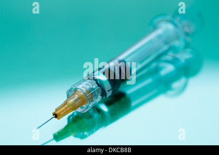 Disposable plastic medical syringe with attached hypodermic needle Stock Photo