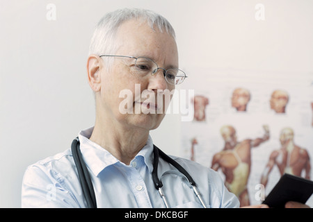 a laughing  woman doc with a human muscle person poster in the background and Stock Photo