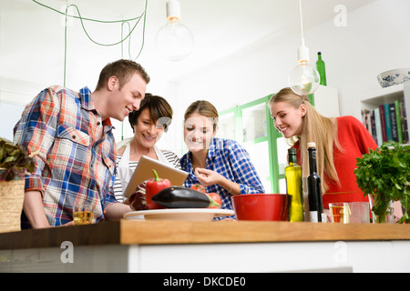 Mother, daughters and son preparing food Stock Photo
