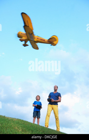 Father and son flying model plane Stock Photo