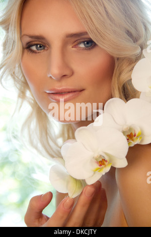 Portrait of woman with orchids Stock Photo
