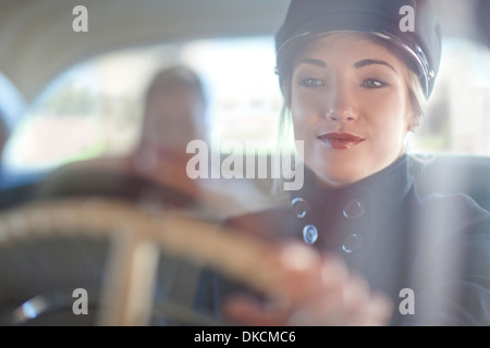 https://l450v.alamy.com/450v/dkcmc6/woman-playing-chauffeur-in-vintage-car-dkcmc6.jpg