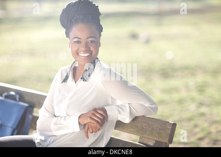 Business woman on park bench Stock Photo