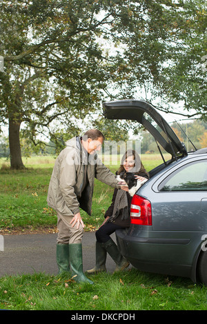 Senior couple out with dog Stock Photo