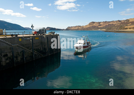 Small passenger ferry arriving at the harbour at the village of Inverie on the Knoydart Peninsula, Highland Region, Scotland, UK Stock Photo