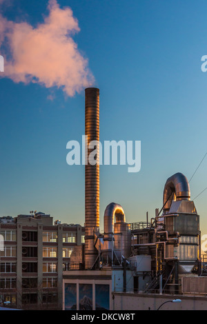 Seattle Steam Co. pipes and smokestack atop their building on the Seattle waterfront, Washington State USA Stock Photo