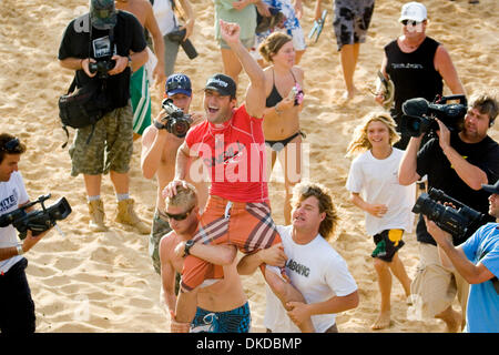 Dec 06, 2006; North Shore, HI, USA; Surfing: O'Neill World Cup of Surfing, November 24-Dec 6 2006. Current ASP world number six JOEL PARKINSON (Coolangatta, Gold Coast, Aus) (C) is carried up the beach by Australian mates MICK FANNING (L) and MARK OCCHILUPO (R) moments after he clinched the O'Neill World Cup of Surfing title at Sunset Beach, Hawaii today. Parkinson posted the only  Stock Photo