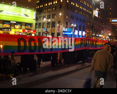 New York, USA. 3rd December 2013. Demonstrators hold a banner protesting the politics of Russian President Vladimir Putin outside the Elton John concert at Madison Square Garden on December 3, 2013 in New York City. Credit:  Cheryl Moulton/Alamy Live News Stock Photo