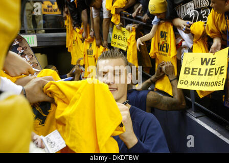 Golden State Warriors' Andris Biedrins, center, and teammate Josh Powell, back right, sign memorabila to fans before the  third playoff game against  the Dallas Mavericks at the Oracle Arena in Oakland, Calif., on Friday Apr. 27, 2007.  (Ray Chavez/The Oakland Tribune) Stock Photo