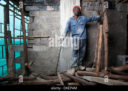 Construction worker on a high rise building site, Nairobi, Kenya Stock Photo