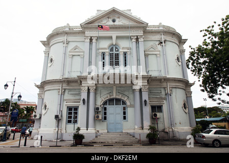 It's a photo in the streets of Georgetown in Penang in Malaysia. We can see a Colonial Building  or tower or arcades Stock Photo