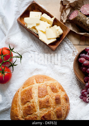 Bread, cheese, salami, grapes and tomatoes Stock Photo