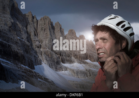 Climber in Brenta Dolomites, Italy, preparing for climb Stock Photo