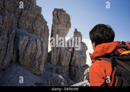 Climber looking at rocky walls, Brenta Dolomites, Italy Stock Photo