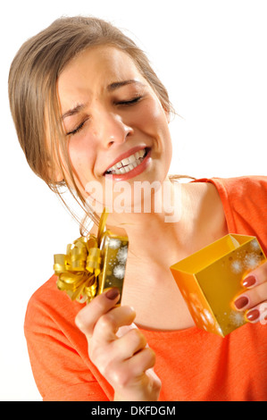 reaction of a girl when open a gift box isolated over white background Stock Photo