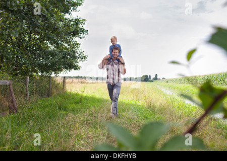 Father carrying son on shoulders Stock Photo