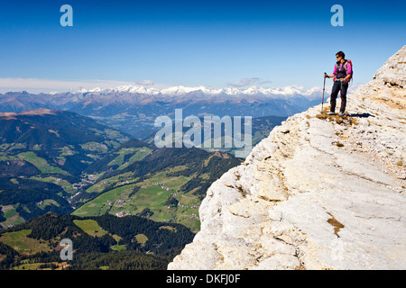 Mountain climber on Kreuzkofelscharte while ascending the Heiligkreuzkofelsteig climbing route on Heiligkreuzkofel Mountain in Stock Photo