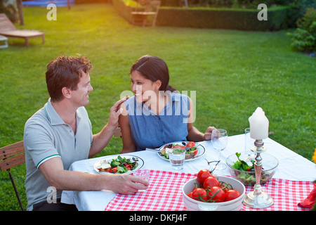 Couple having dinner in garden Stock Photo