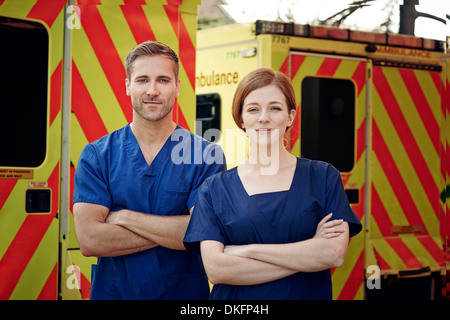 Portrait of two emergency medical technicians next to ambulance Stock Photo