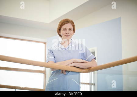 Portrait of female nurse in hospital atrium Stock Photo