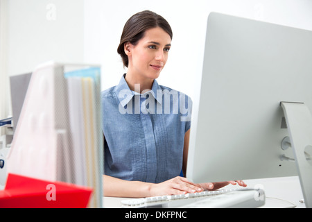 Young woman working on computer Stock Photo