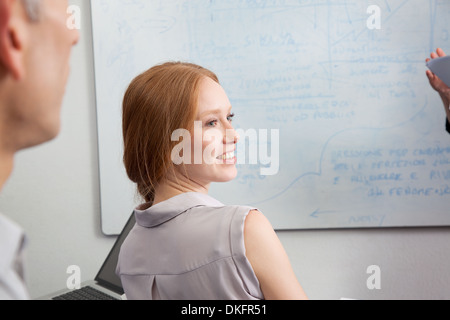 Young woman looking over shoulder Stock Photo