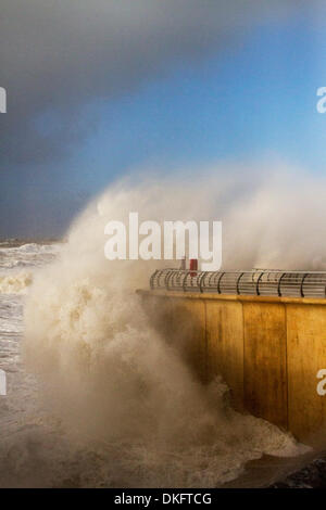 Blackpool, Lancashire, UK   5th December, 2013.  UK Weather.  Storm surge seas, breaking waves and High Tide force closure of Blackpool promenade to vehicles and pedestrians as high winds and flooding disrupts the town. 'Storm surges begin when a rising area of low pressure takes pressure off the surface of the sea, allowing it 'bulge' upwards,  as that pulls away, you get the very strong winds on the back edge of the low pressure and then that shoves that bulge of high sea levels down through the North Sea.'  Wind speeds were measured at 67mph. Stock Photo