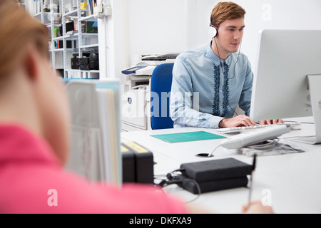 Young man using computer in office Stock Photo