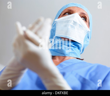 Surgeon clasping hands together Stock Photo