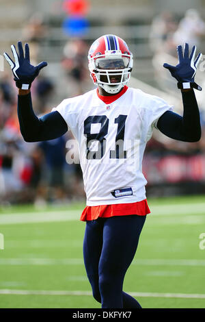 Buffalo Bills' Terrell Owens celebrates his touchdown on the replay screen  as a worker clears snow off the field during the NFL football game against  the Indianapolis Colts in Orchard Park, N.Y.