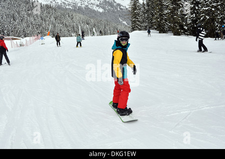 Snowboarding boy in Austrian Ski resort. Model Released Stock Photo