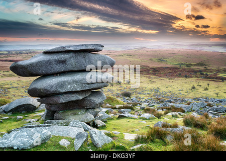 Sunset at the Cheesewring on Bodmin Moor in Cornwall, a weathered natural rock formation made up of precariously balanced granit Stock Photo