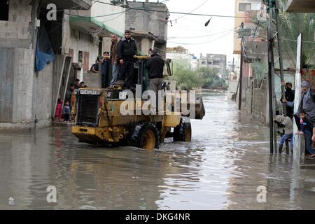 Gaza City, Gaza Strip, Palestinian Territory, . 5th Dec, 2013. Palestinians ride a bulldozer in a flooded street following heavy rainfall in Gaza City on December 5, 2013 Credit:  Ashraf Amra/APA Images/ZUMAPRESS.com/Alamy Live News Stock Photo