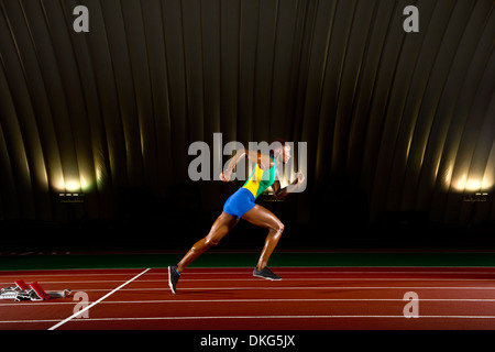 Young woman sprinting in stadium Stock Photo