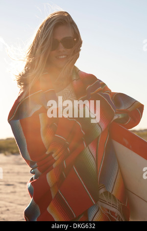 Young woman wrapped in blanket, Breezy Point, Queens, New York, USA Stock Photo