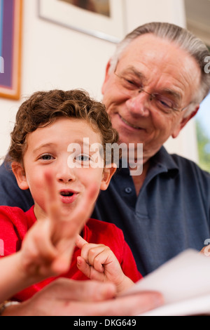 Portrait of young boy and grandfather playing Stock Photo